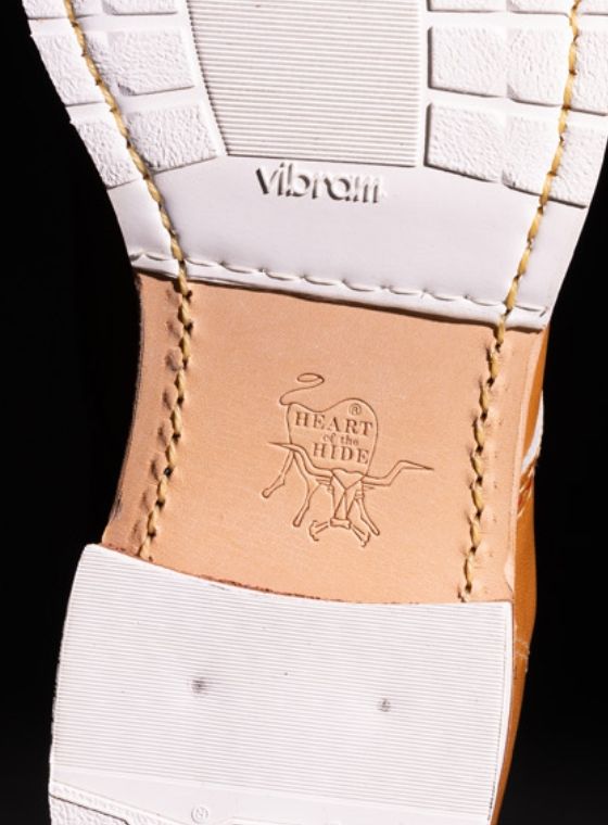 The bottom of a tan leather boot, displaying the Vibram logo.