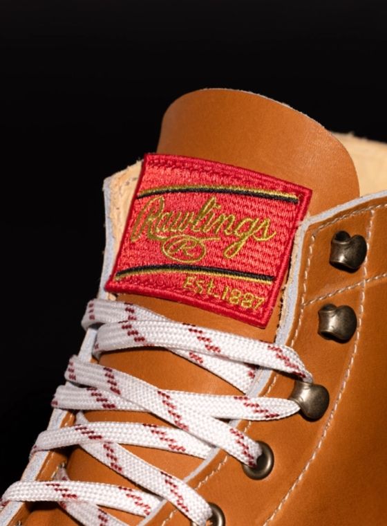 The tongue of a tan leather boot with the Rawlings logo sewn into it.