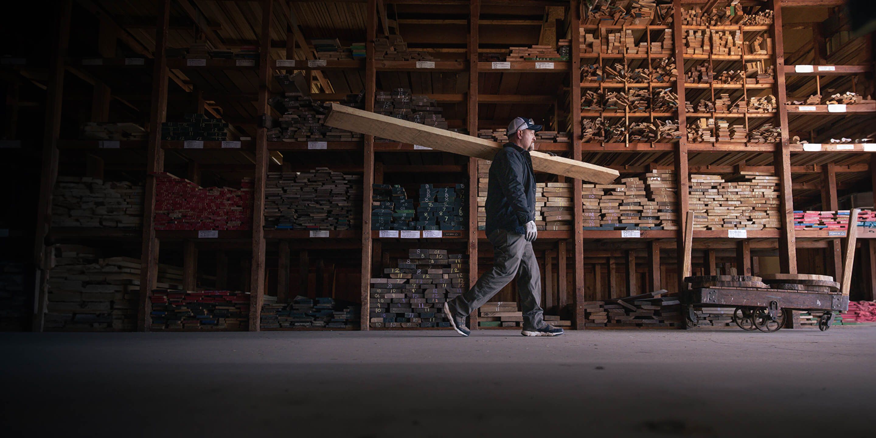 a man carrying a large piece of wood