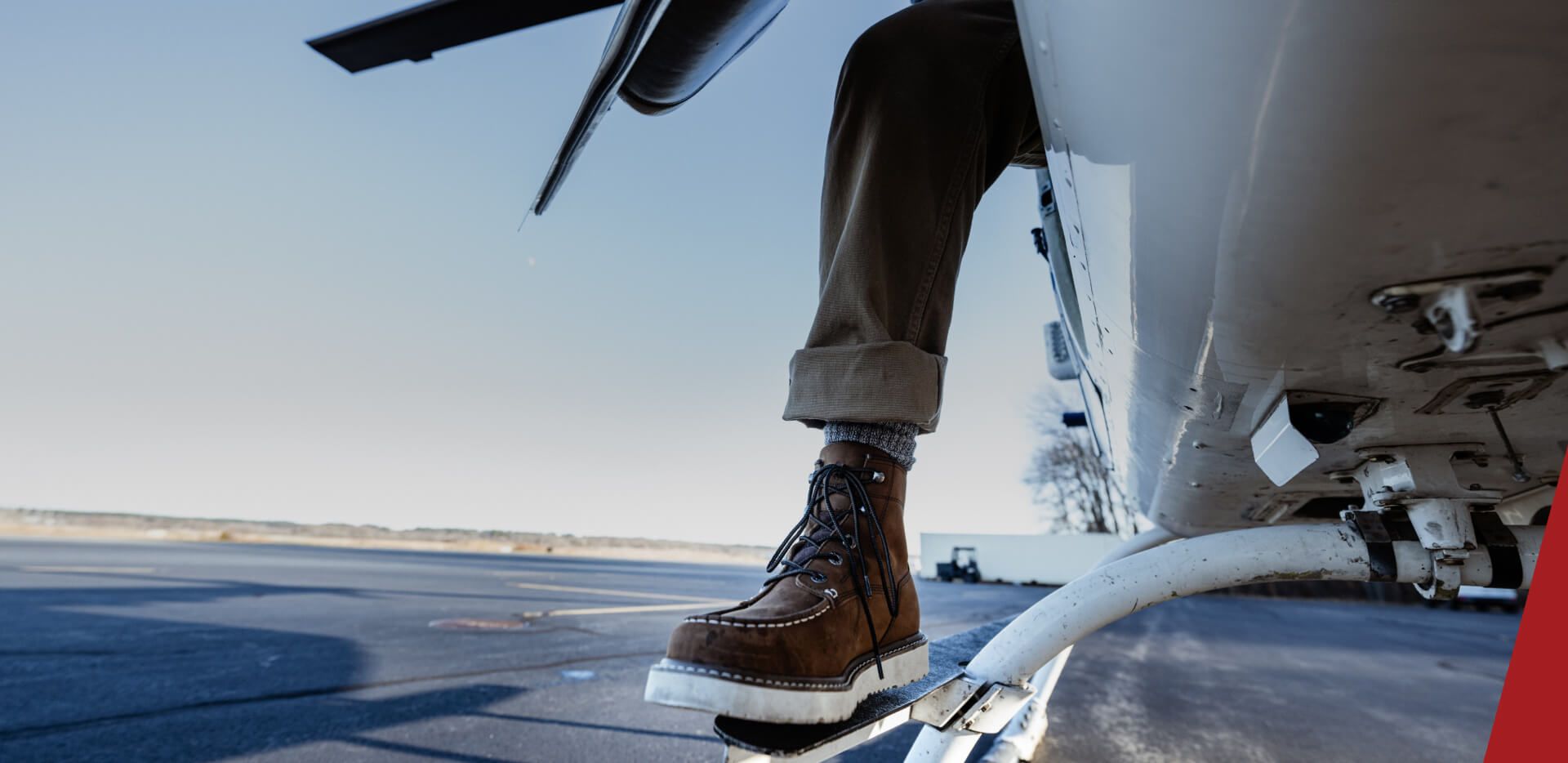 a boot dangling out the side of a helicopter