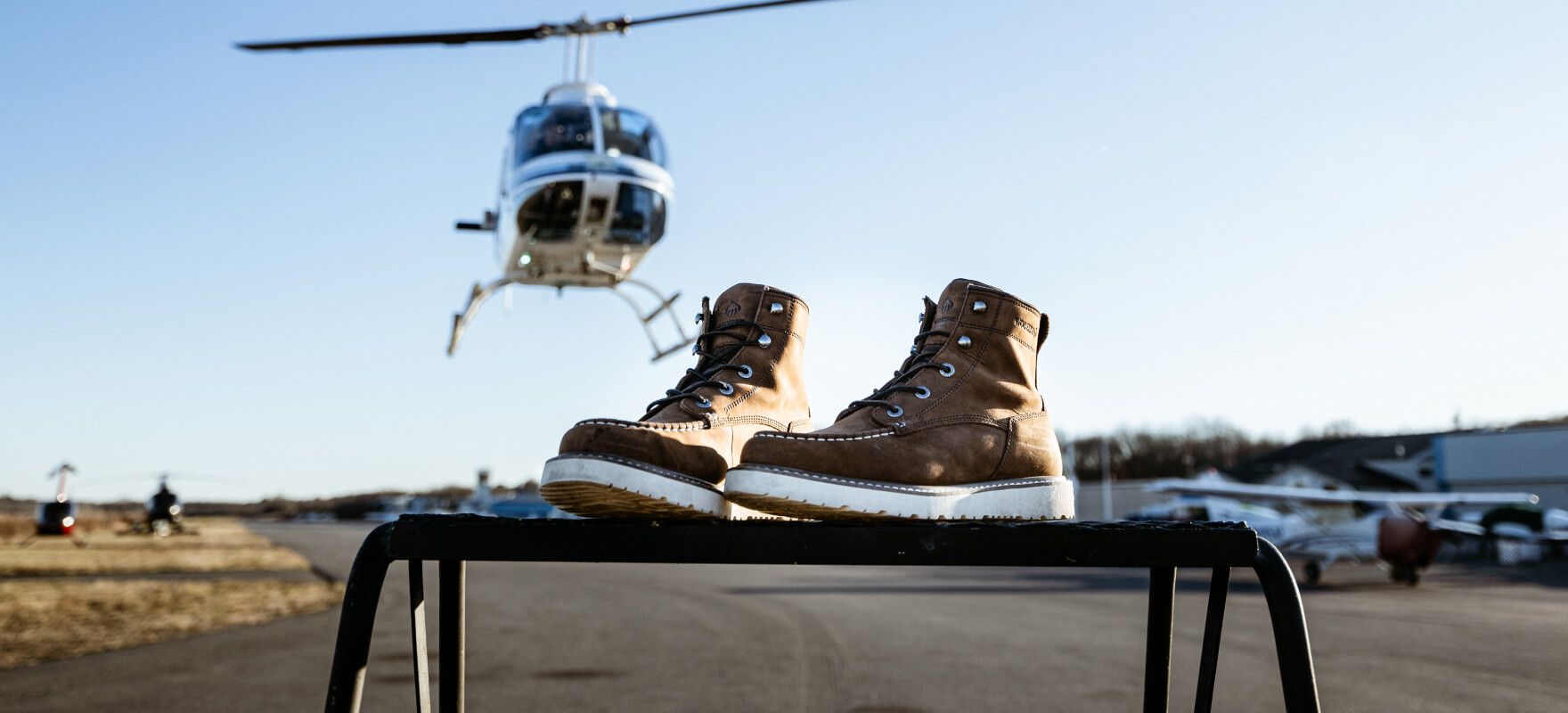 Boots with a helicopter in the background