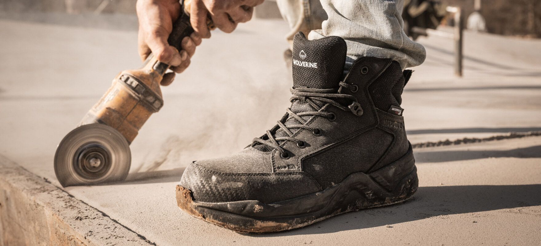 a person cutting a concrete slab